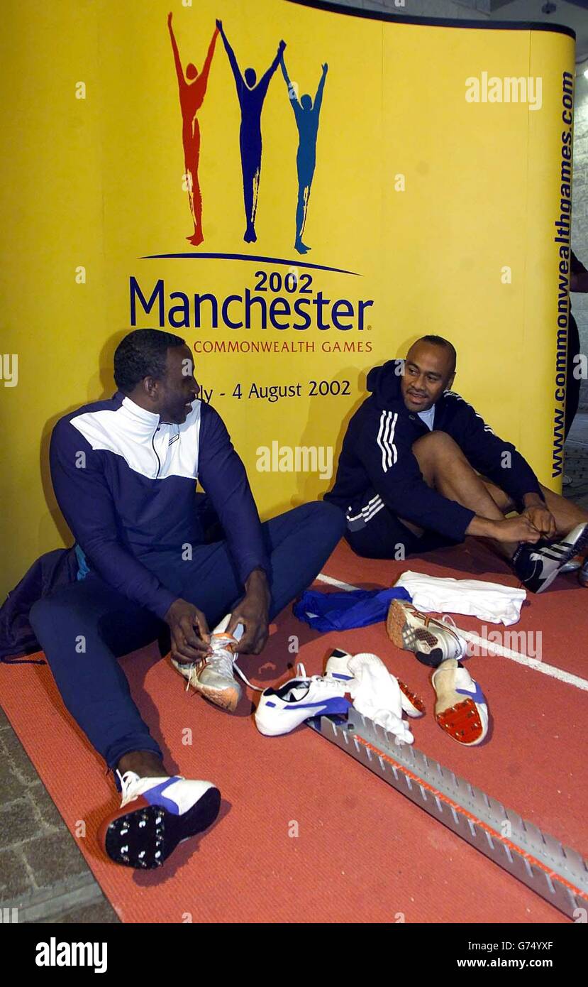 Linford Christie (left) and Jonah Lomu in coversation as they prepare for the 50 metre sprint race at The Printworks, Manchester. New Zealand All Blacks' Jonah Lomu took on former Olympic gold medalist Linford Christie in a head-to-head 50 metre sprint as part of the countdown towards the 2002 Commonwealth Games. Linford won the race against Jonah. Stock Photo
