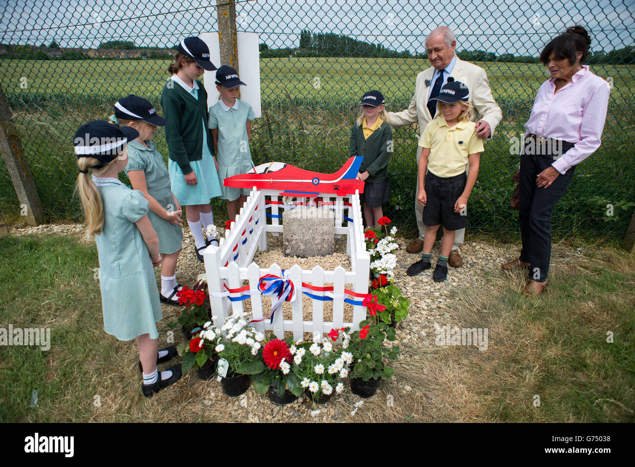 Henry Prince, a member of the first Red Arrows' team, with his wife Nikki and children from Kempsford Primary School, as they visit the newly restored gravestone at RAF Fairford of his dog Dusty, who was a mascot of the team. Stock Photo