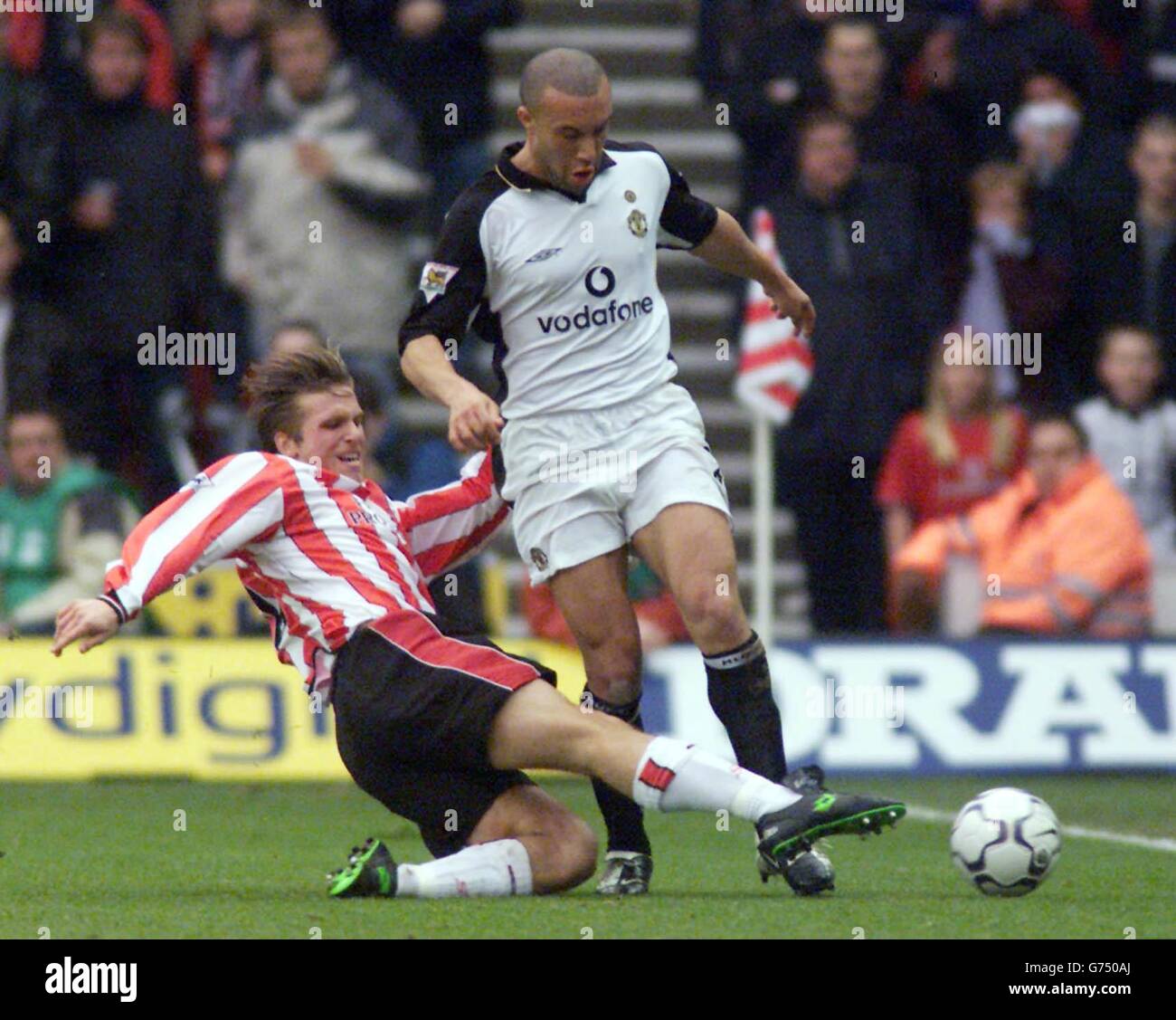 Mikael Silvestre (right) for Manchester United is tackled by Anders Svensson of Southampton, during their FA Barclaycard Premiership match at St Mary's Stadium. Stock Photo