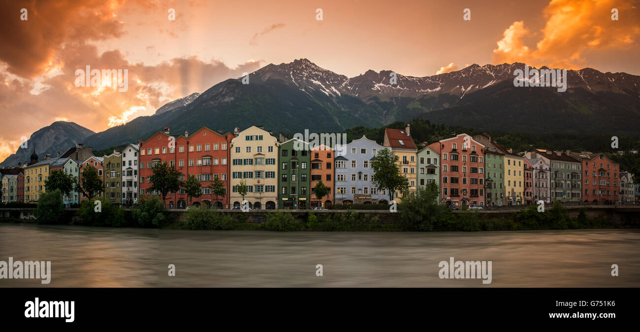 Panoramic view at sunset over colorful buildings along Inn river, Innsbruck, Tyrol, Austria Stock Photo