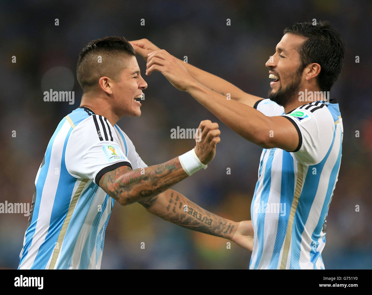 Argentina's Ezequiel Garay (front) and Argentina's Marcos Rojo celebrate after Bosnia and Herzegovina's Sead Kolasinac scores an own goal Stock Photo