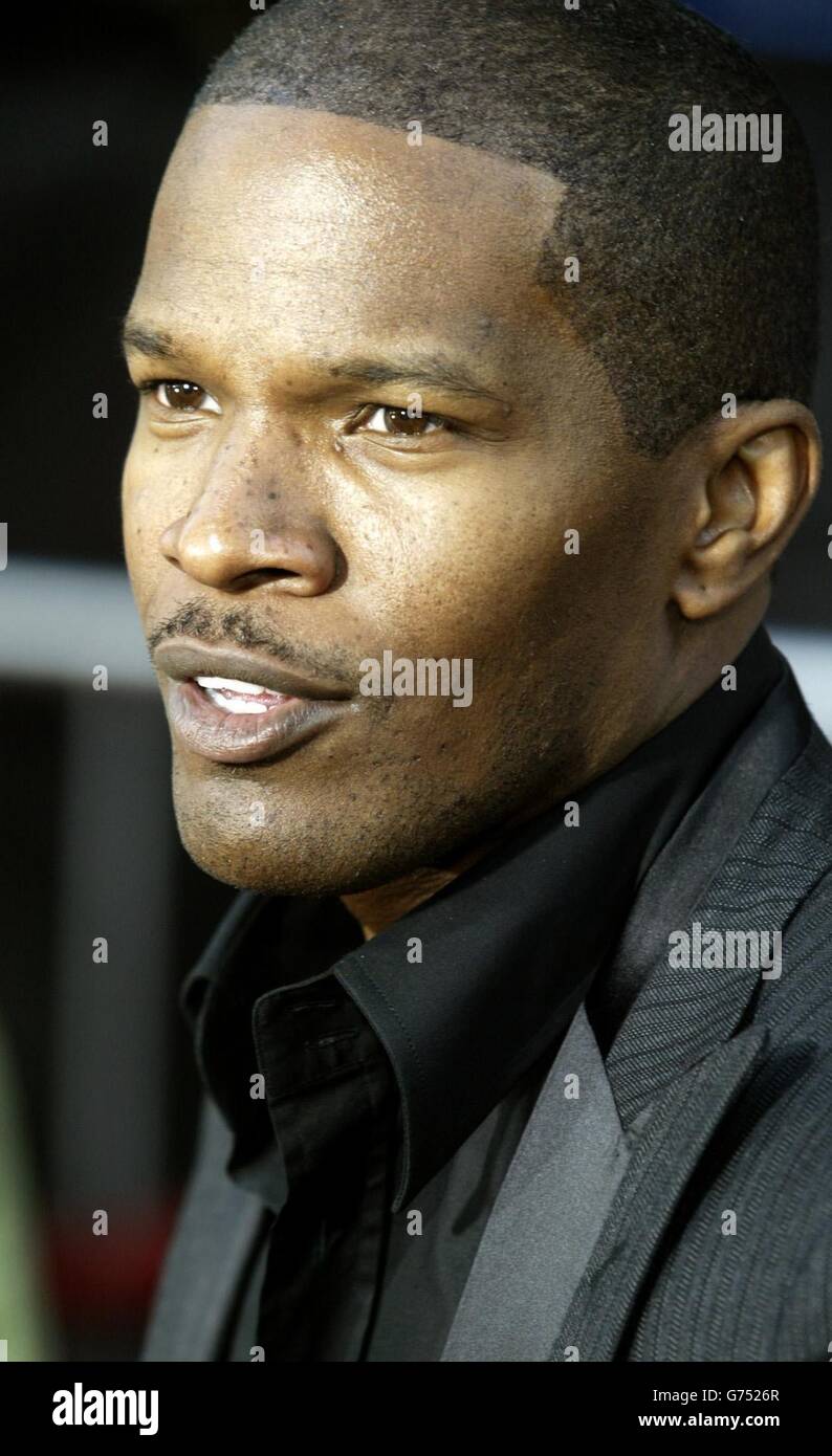 Actor Jamie Foxx, one of the stars of the new thriller film 'Collateral' poses next to a movie poster from the film as he arrives at the film's premiere in Los Angeles. The film tells the story of a cab driver, played by Jamie Foxx, who finds himself the hostage of an engaging contract killer, played by Tom Cruise , as he makes his rounds from hit to hit during one night in Los Angeles.The film, directed by Michael Mann opens August 6 in the United States. Stock Photo