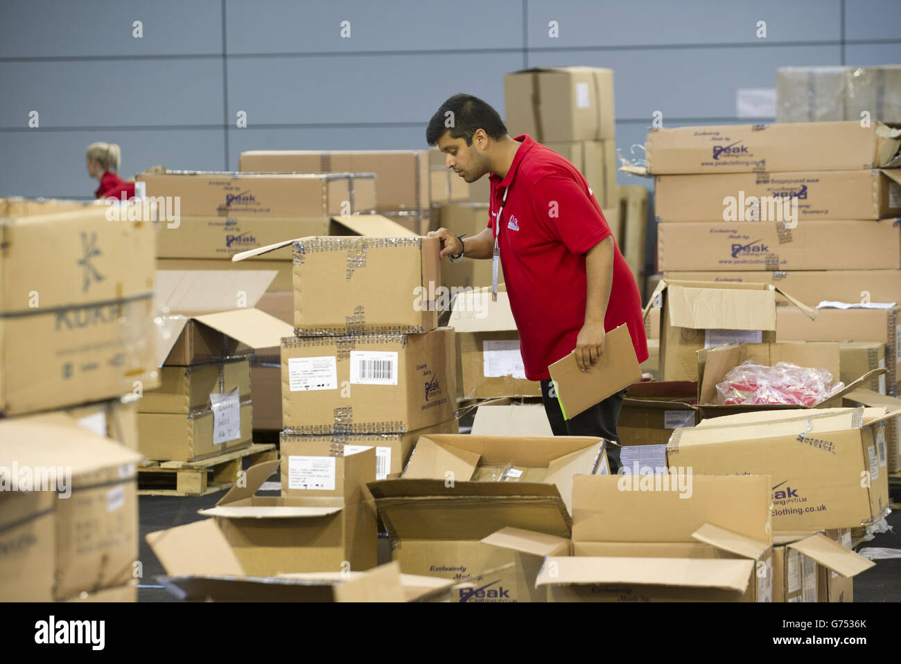 Stock pickers fill the athlete's bags with clothing for the Commonwealth Games during a kitting out session at St George's Park, Burton. Stock Photo