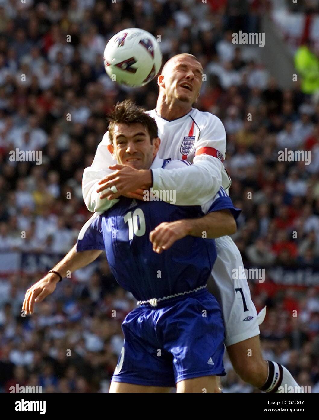 England Captain David Beckham grapples with Greece's Giorgos Karagounis during the FIFA World Cup European Qualifying Group Nine match at Old Trafford, Manchester. eg Stock Photo