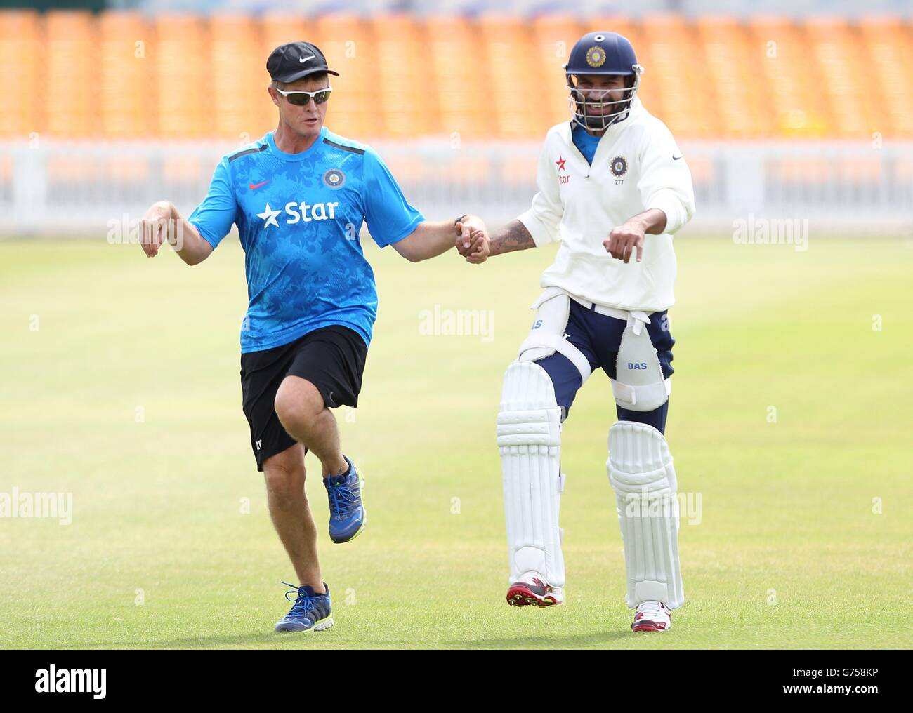 India fielding coach Trevor Penney (left) and Shikhar Dhawan minic the rest of the teams warm up