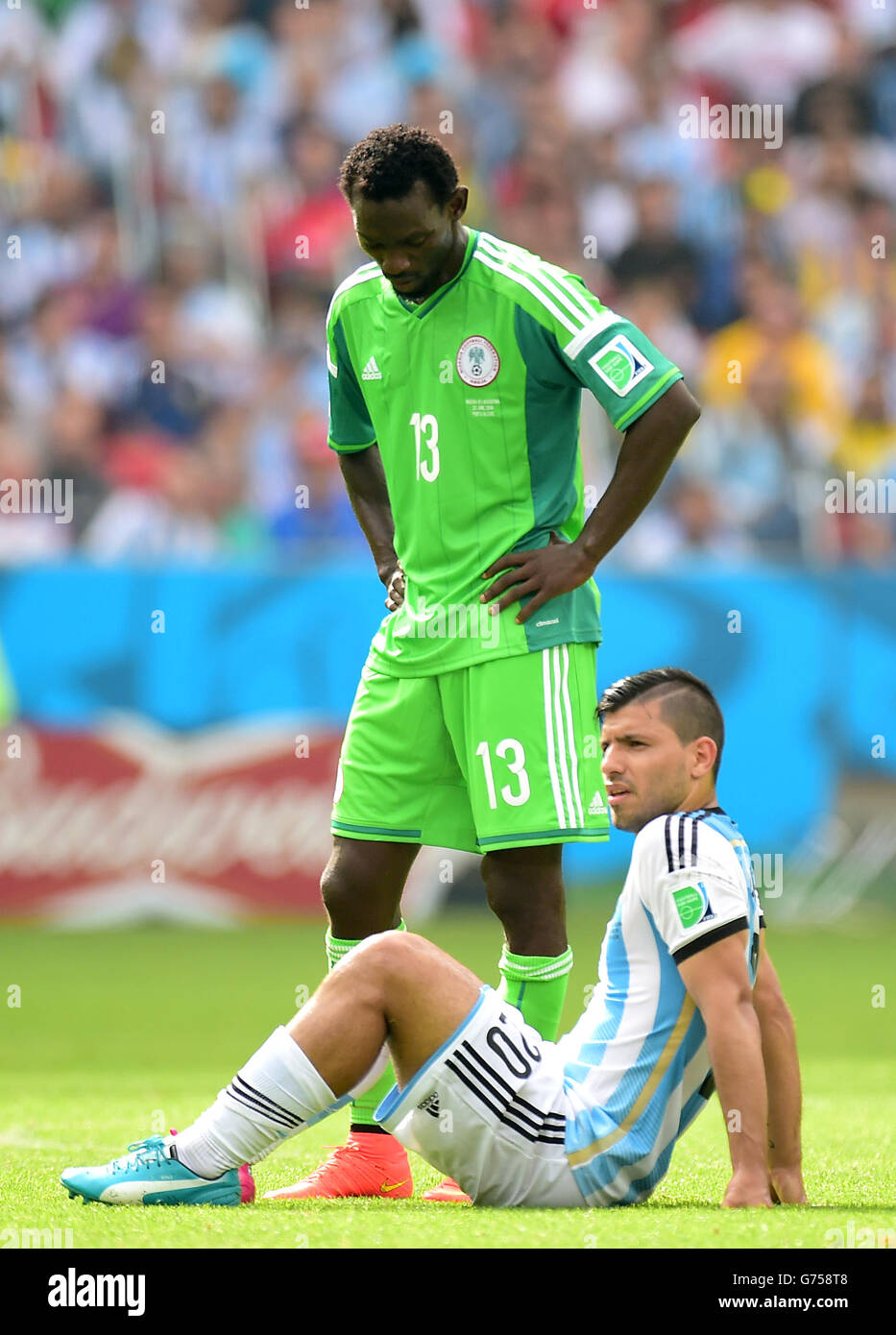 Soccer - FIFA World Cup 2014 - Group F - Nigeria v Argentina - Estadio Beira-Rio. Nigeria's Juwon Oshaniwa (rear) and and Argentina's Sergio Aguero look dejected Stock Photo