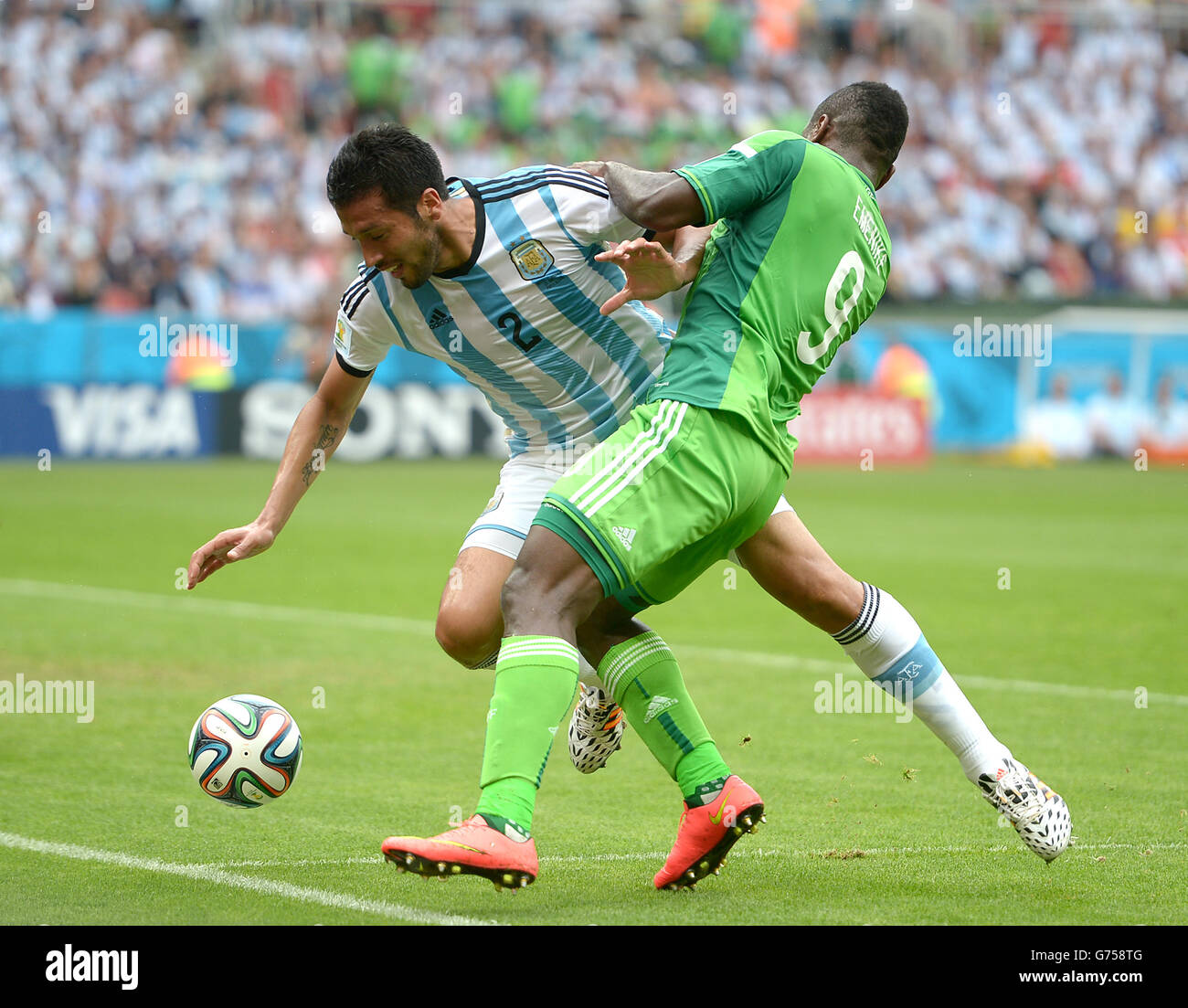 Soccer - FIFA World Cup 2014 - Group F - Nigeria v Argentina - Estadio Beira-Rio. Nigeria's Emmanuel Emenike (right) and Argentina's Ezequiel Garay battle for the ball Stock Photo