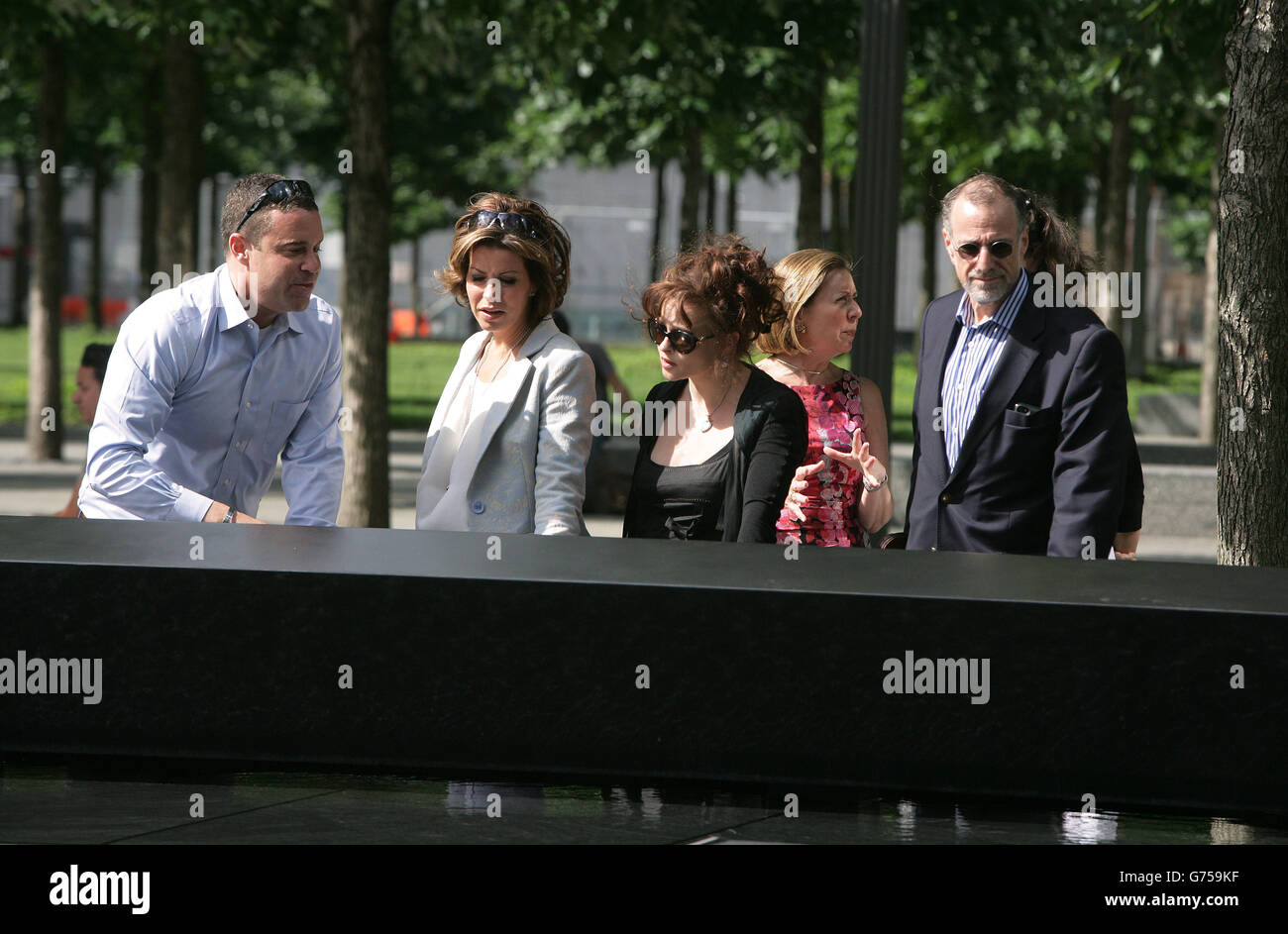Members of the Prime Minister's Holocaust Commission Natasha Kaplinsky (second left), Helena Bonham Carter (centre) and Mick Davis (right) during a visit to the 9/11 memorial and Memorial Museum in New York, USA. Stock Photo