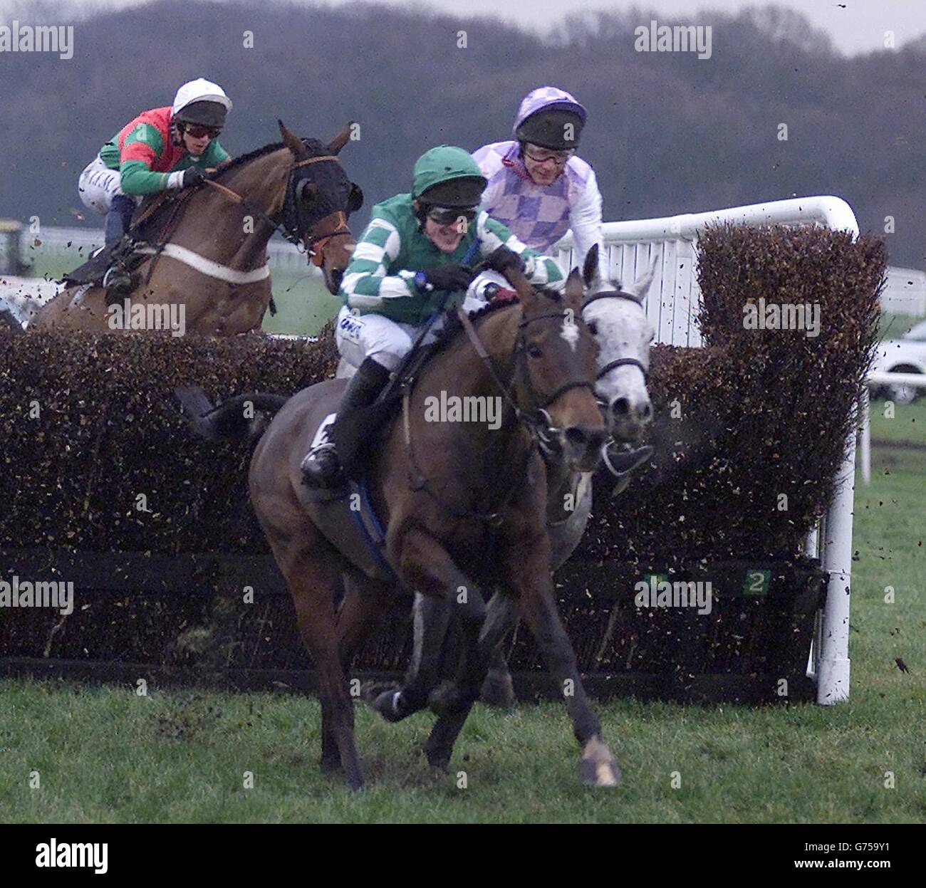 Haydock B The One Carrick Troop. Legal Right (centre) ridden by Tony McCoy gets after the final fence to win the Tommy Whittle Steeple Chase at Haydock Park. Stock Photo