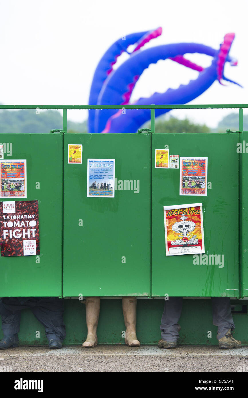 Festivalgoers using the newly installed long drop toilets in the rain
