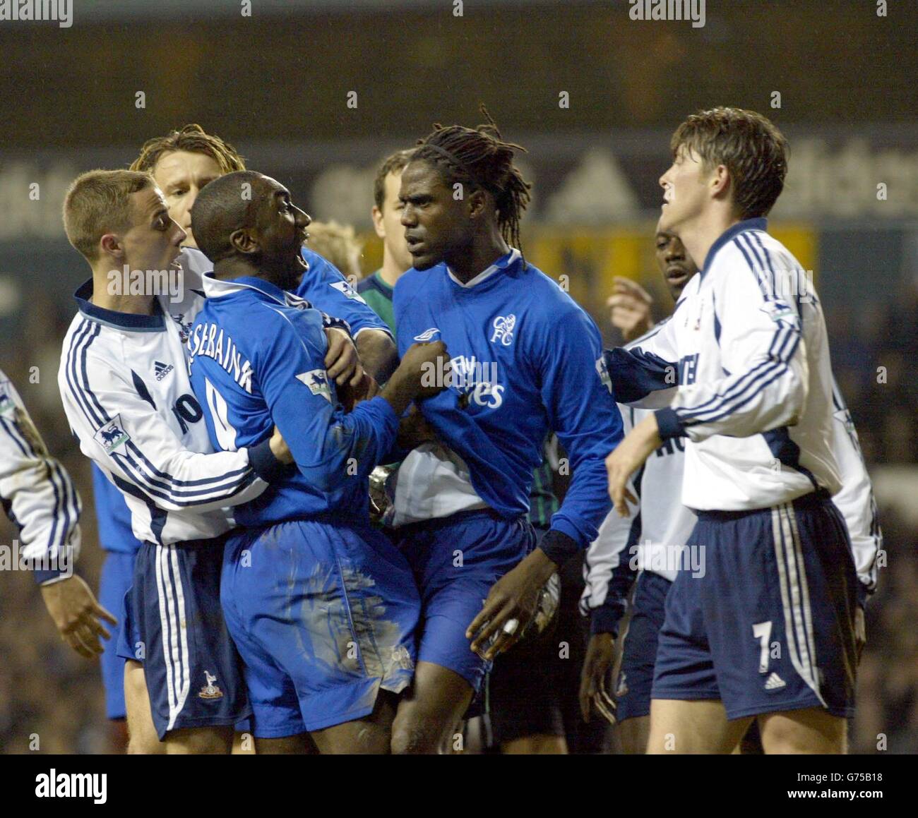 Chelsea's Jimmy Floyd Hasselbaink is restrained by his team-mate shortly before Jimmy Floyd Hasselbaink was red carded. After 55 minutes, Hasselbaink fouled Sullivan and that sparked a melee inside the Spurs box. * Referee Mark Halsey brandished the red card at the big striker for pushing Sheringham in the face but he got the wrong Dutchman as Mario Melchiot was the real offender, during their Worthington Cup semi-final, 2nd leg match at Tottenham's, White Hart Lane ground. Stock Photo