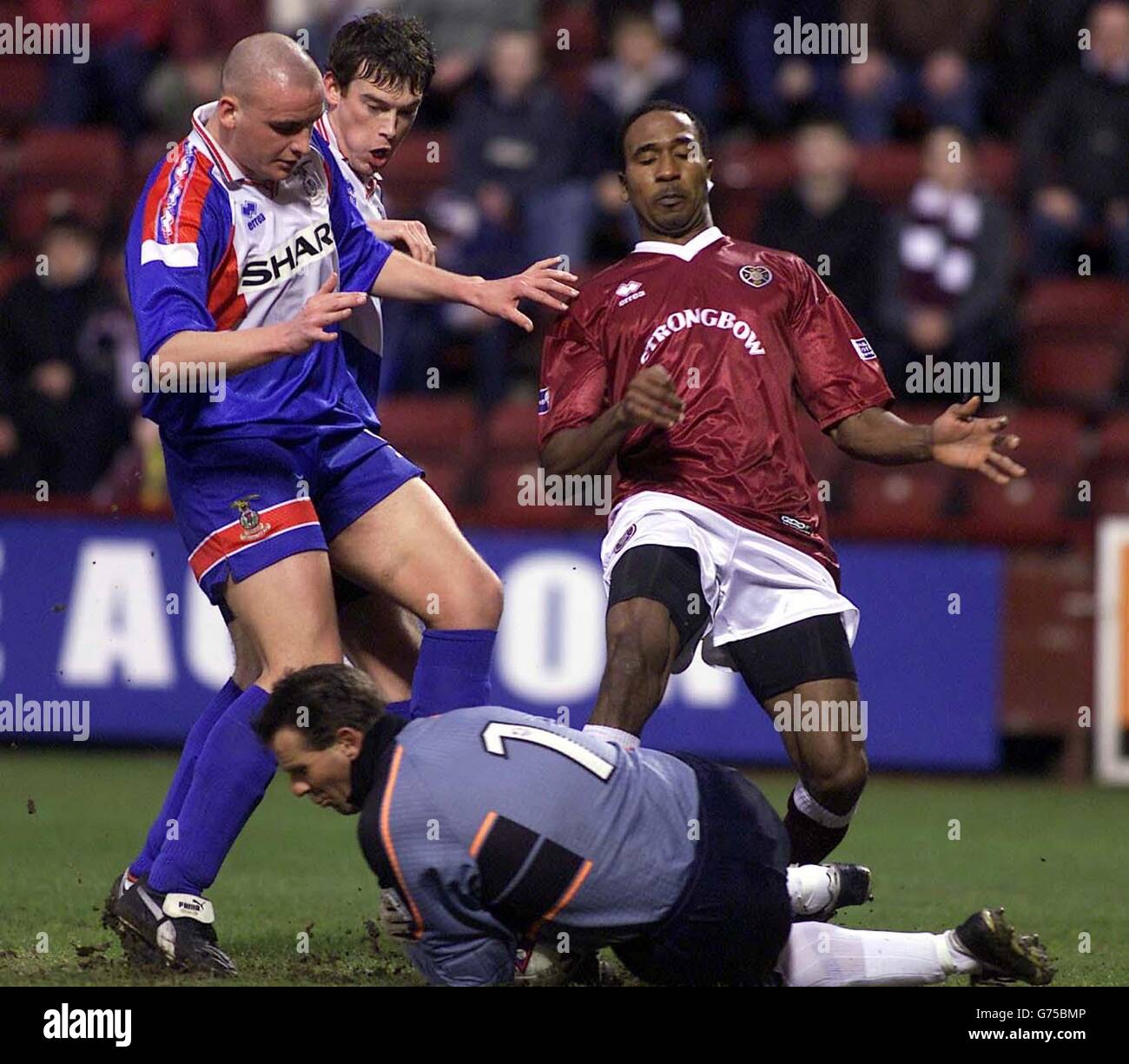 Inverness Caledonian Thistle goalkeeper Nicky Walker saves from the feet of Hearts' Ricardo Fuller, during their Tennents Scottish FA Cup 4th round match at Hearts' Tynecastle Park ground in Edinburgh. Stock Photo