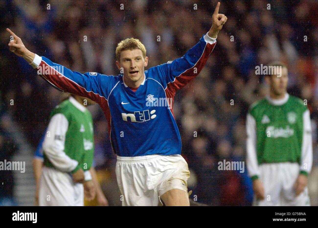 Rangers Tore Andre Flo celebrates his second goal to put Rangers on their way to a 4-1 win in their Tennents Scottish FA Cup 4th round match at Rangers' Ibrox stadium in Glasgow. Stock Photo
