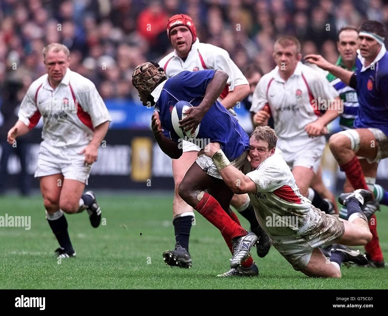 England's Matt Tindall (right) tries to hold French forward Serge Betsenduring their Lloyds TSB Six Nations match at the Stade de France in Paris, France. Stock Photo