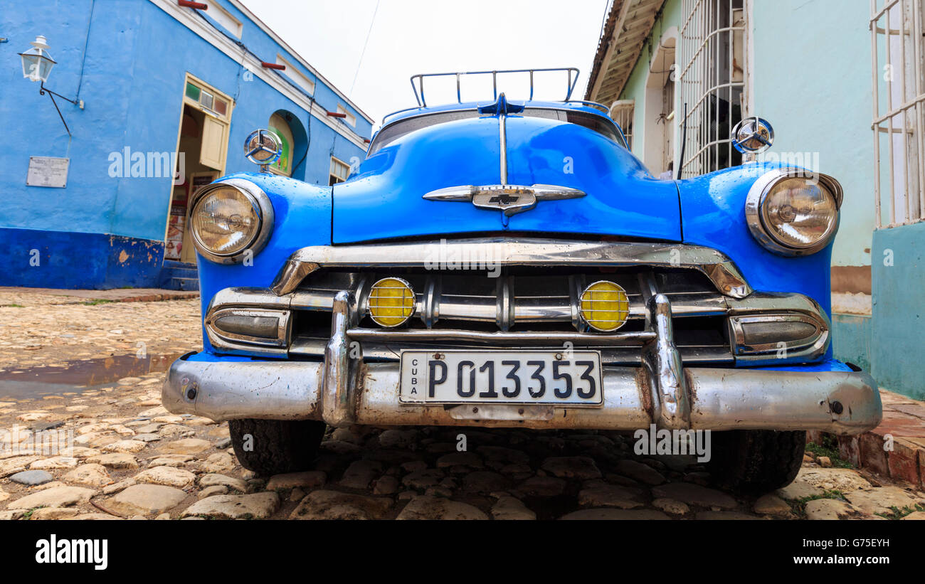 Blue American Chevrolet classic car from the 1950s parked in a cobbled street in the historic colonial city of  Trinidad, Cuba Stock Photo