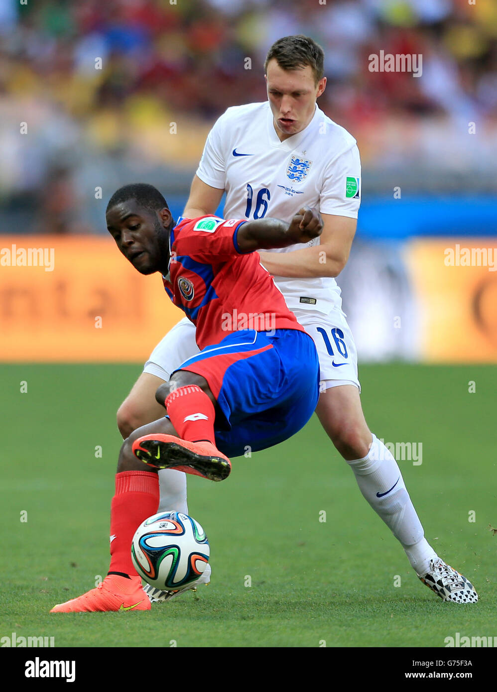 Costa Rica's Joel Campbell (left) and England's Phil Jones battle for the ballduring the FIFA World Cup, Group D match at the Estadio Mineirao, Belo Horizonte, Brazil. Stock Photo
