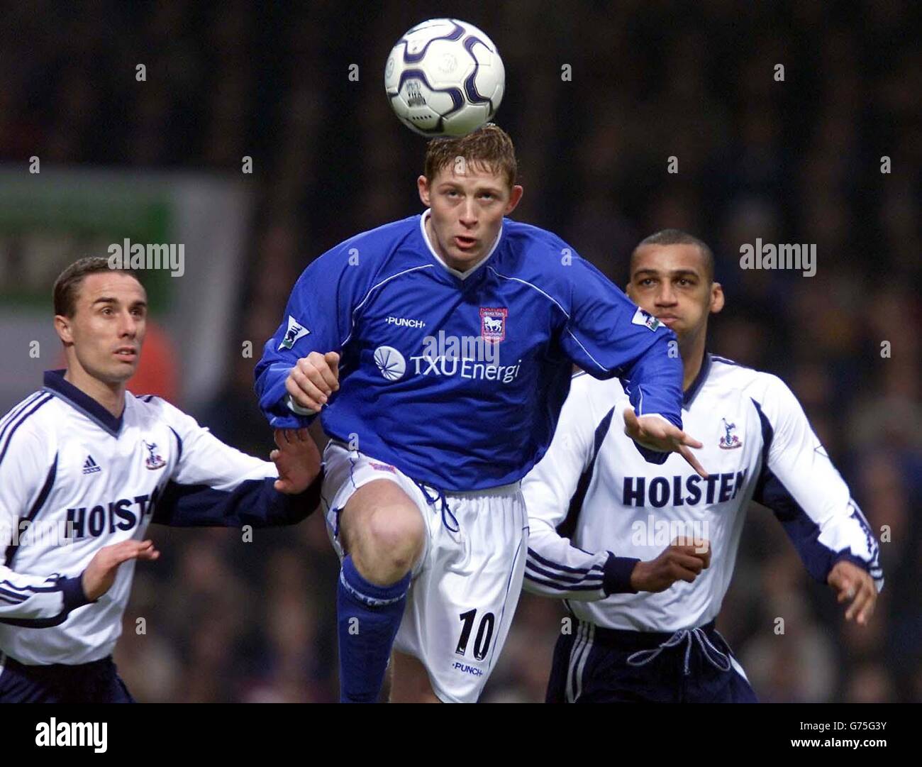 Ipswich Town's Alun Armstrong goes up for the high ball with Tottenham Hotspurs' Chris Perry (left) and Dean Richards (right), during their FA Barclaycard Premiership match at Ipswich's Portman Road ground. Stock Photo