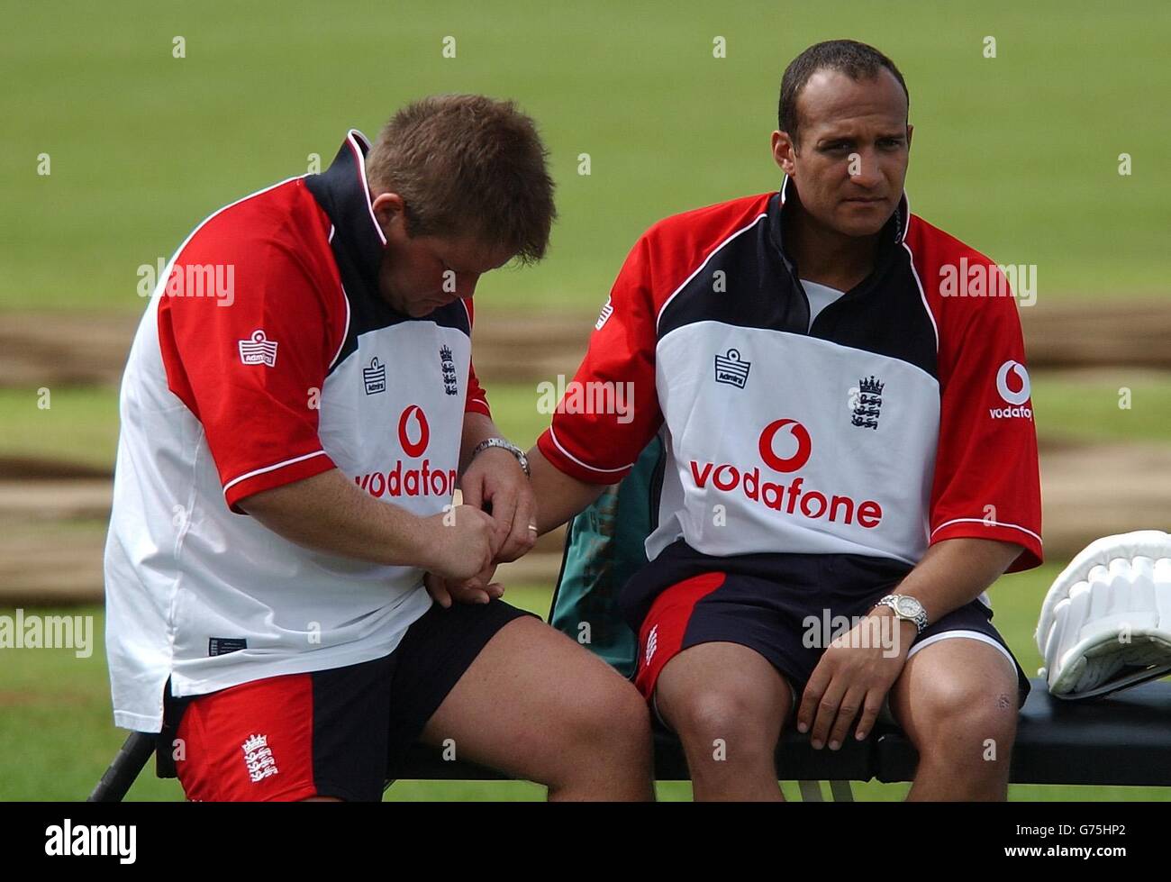 England physio Dean Conway (left) works on the injured hand of Mark Butcher during the team net session at Basin Reserve, Wellington. Stock Photo