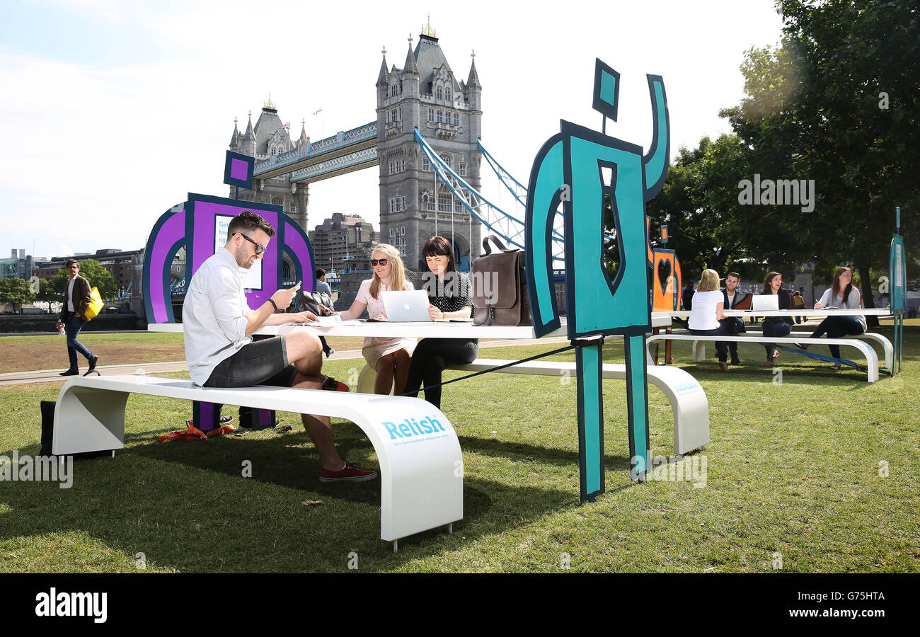 People use the free pop-up wifi hotspots at Potters Fields Park in London which have been installed by Relish, a new 4G wireless network provider for central London. Stock Photo