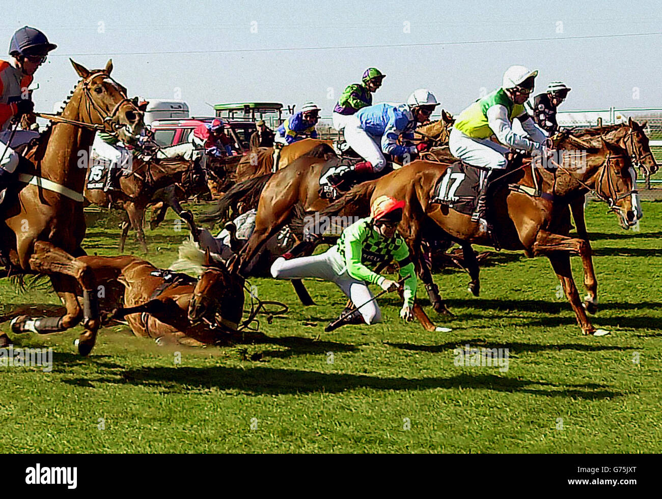Connor O'Dwyer falls of Wicked Crack at the first fence during the Martell Grand National at Aintree. Stock Photo