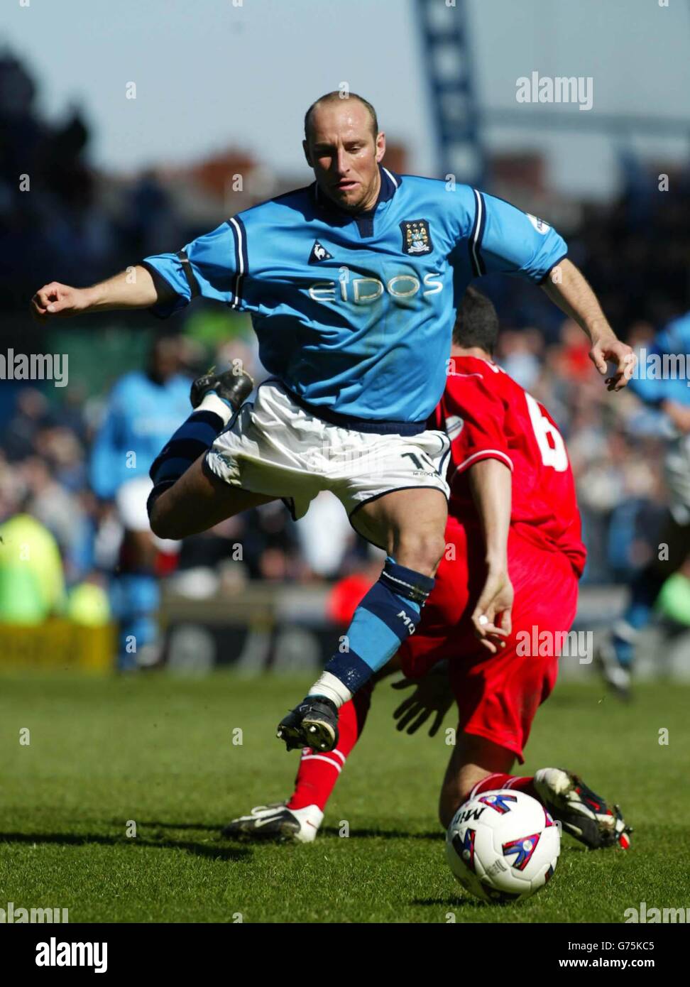 Manchester City's Danny Tiatto escapes the attentions of Barnsley's