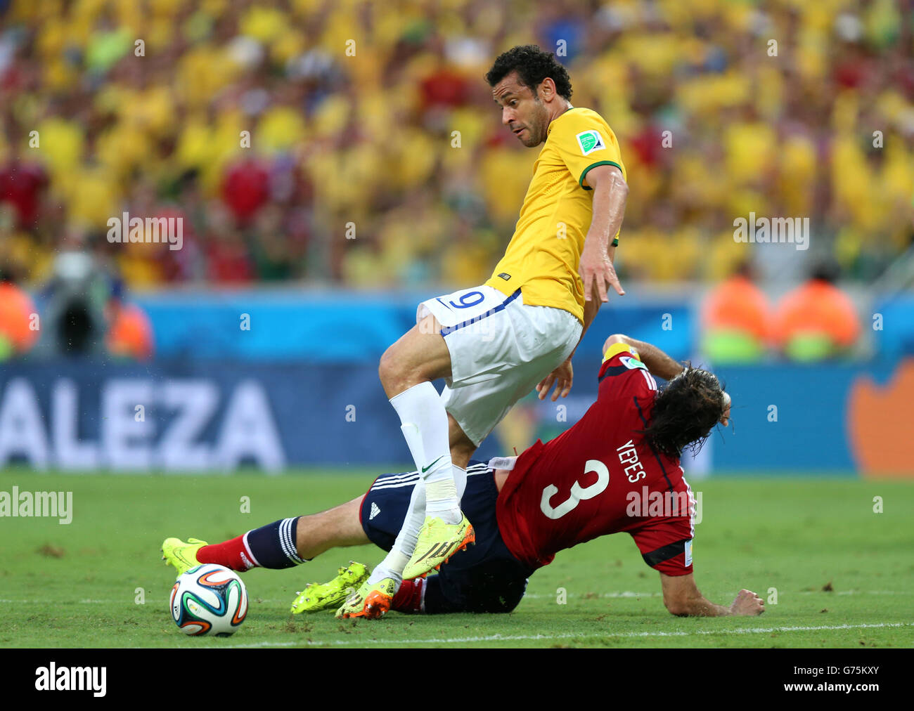 Brazil's Fred (top) and Colombia's Mario Yepes battle for the ball during the quarter final match at the Estadio Castelao, Fortaleza. Stock Photo