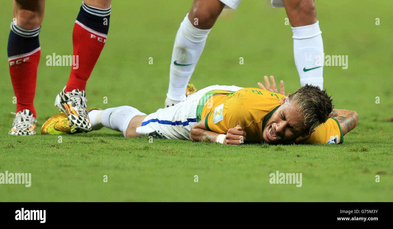 Soccer - FIFA World Cup 2014 - Quarter Final - Brazil v Colombia - Estadio Castelao. Brazil's Neymar lies in pain with a back injury on the pitch during the quarter final match at the Estadio Castelao, Fortaleza. Stock Photo