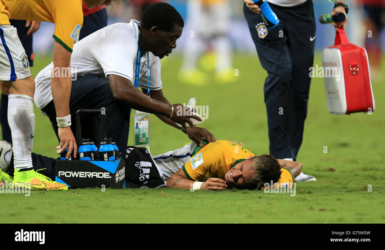Soccer - FIFA World Cup 2014 - Quarter Final - Brazil v Colombia - Estadio Castelao. Brazil's Neymar receives treatment for a back injury on the pitch during the quarter final match at the Estadio Castelao, Fortaleza. Stock Photo