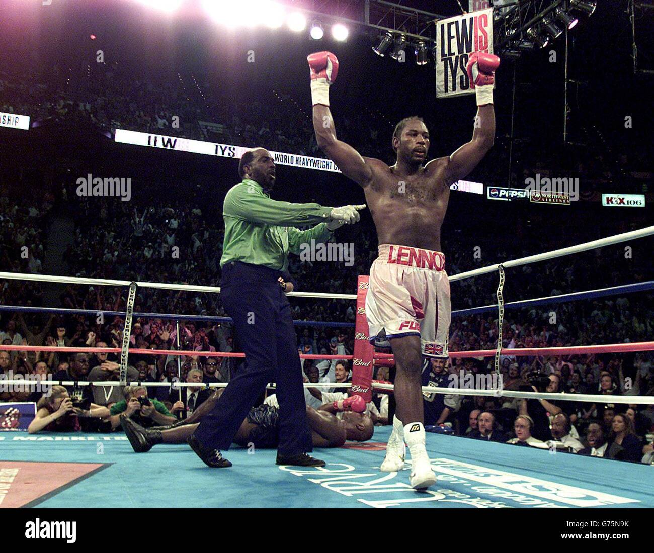 Britain's Lennox Lewis lifts his arms in victory after beating American Mike Tyson at the Pyramid Stadium, Memphis, with an 8th round knockout. Stock Photo