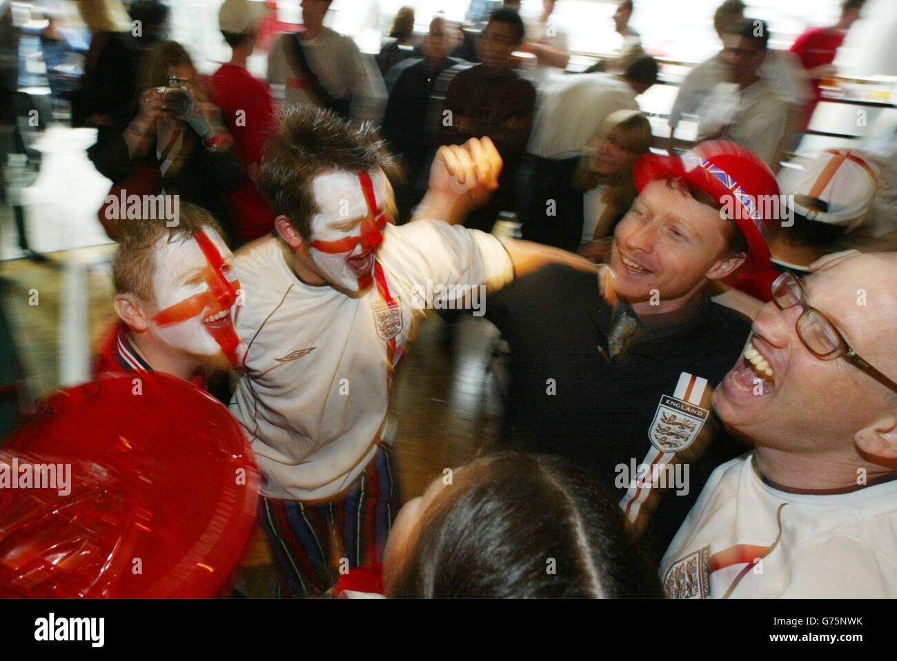 England supporters celebrate at the Sports Cafe, London, as their team