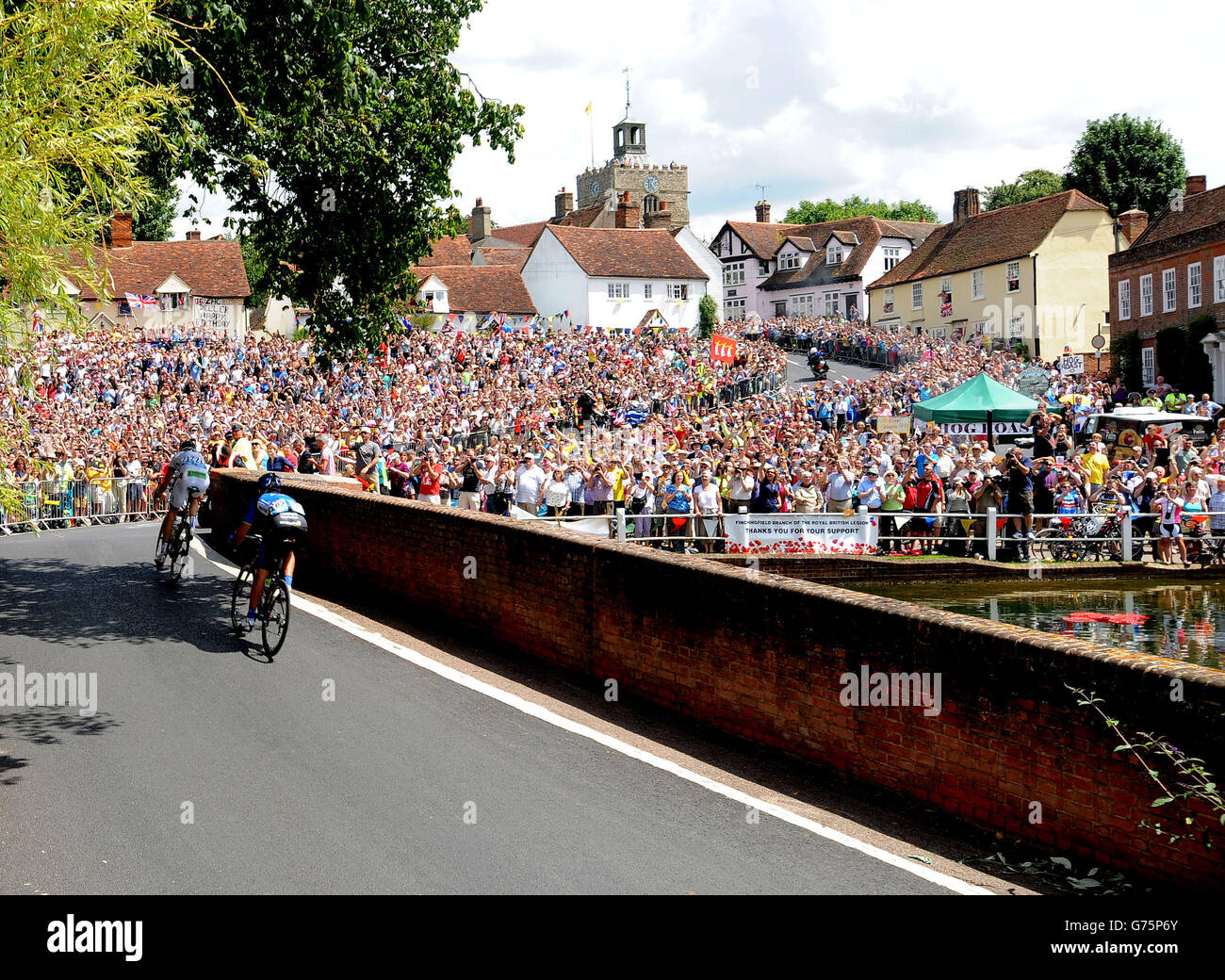 Crowds greet the breakaway riders Jean-Marc Bideau (left) and Jan Barta as they arrive in the village of Finchingfield in north Essex during stage three of the Tour de France from Cambridge to London. Stock Photo