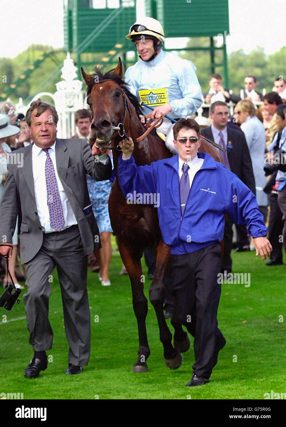 Sir Michael Stoute (left), leads in Golan, with Kieren Fallon up after they had won The King George V1 and Queen Elizabeth Diamond Stakes, at Ascot. Stock Photo