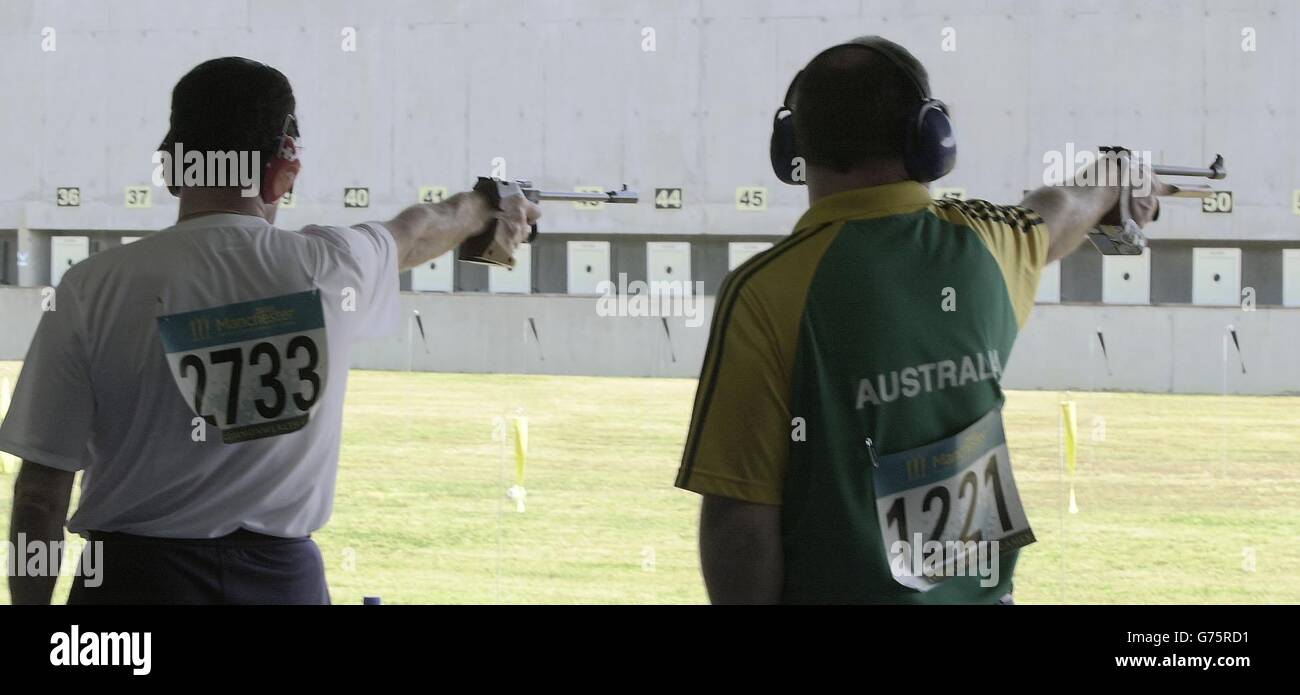 England's Frank Wyatt & Australian Bruce Quick using a pistol which is banned by the Hand Gun law of the mainland UK 1997, during the men's 50 metre Pistol Pairs shooting event of the 2002 Commonwealth Games at the National Shooting Centre, Bisley. Stock Photo