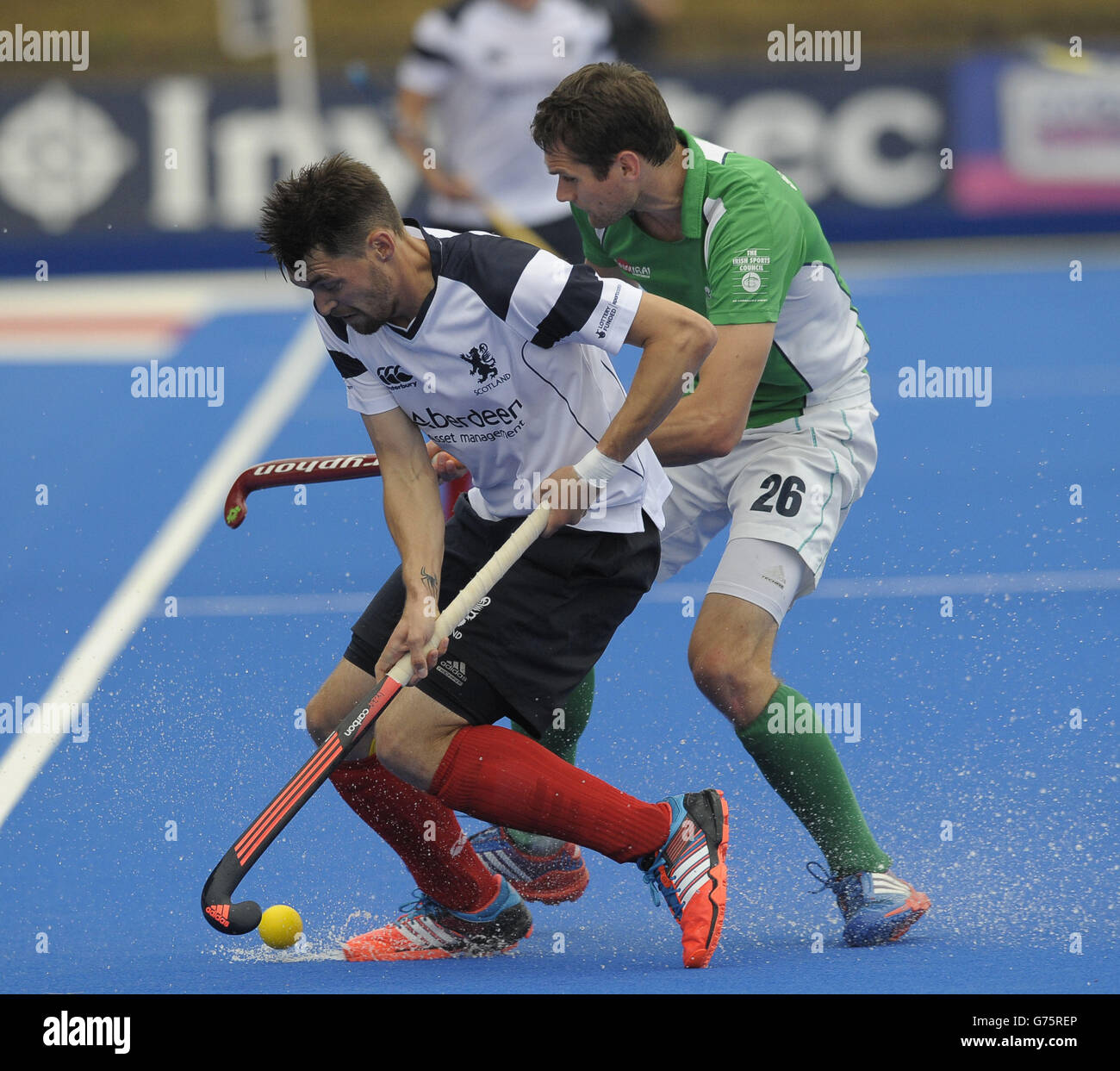 Scotland's Kenny Bain is challenged by Ireland's Paul Gleghorne during the Investec London Cup match at The Lee Valley Hockey and Tennis Centre, London. Stock Photo