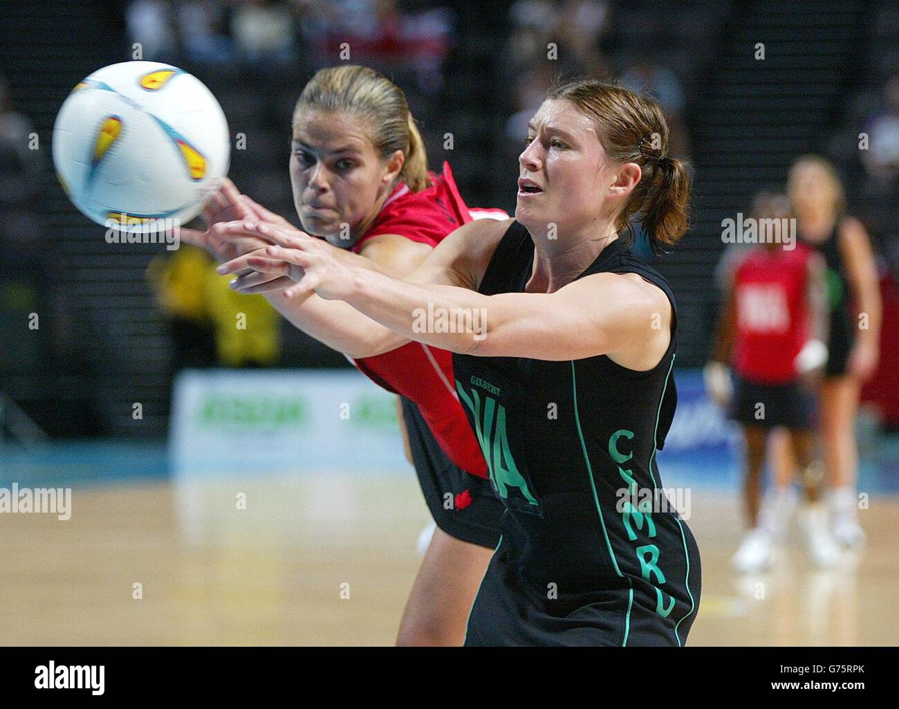Wales Wing Attack Helen Case (R) battles with Canada's Wing Defence Joanne Burns, in Commonwealth Games Womens Netball, at the MEN Arena in Manchester. Stock Photo