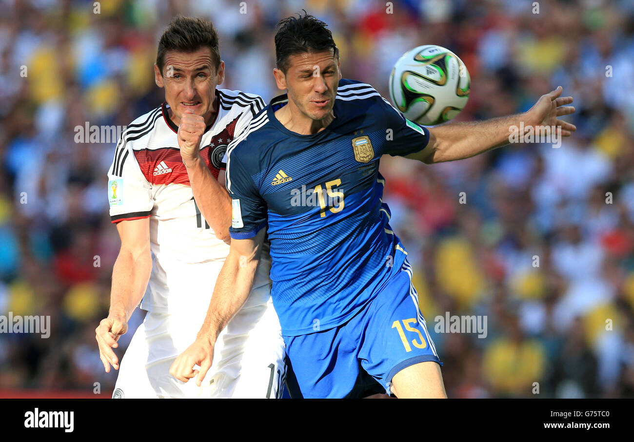 Soccer - FIFA World Cup 2014 - Final - Germany v Argentina - Estadio do Maracana. Germany's Miroslav Klose (left) and Argentina's Martin Demichelis battle for the ball Stock Photo