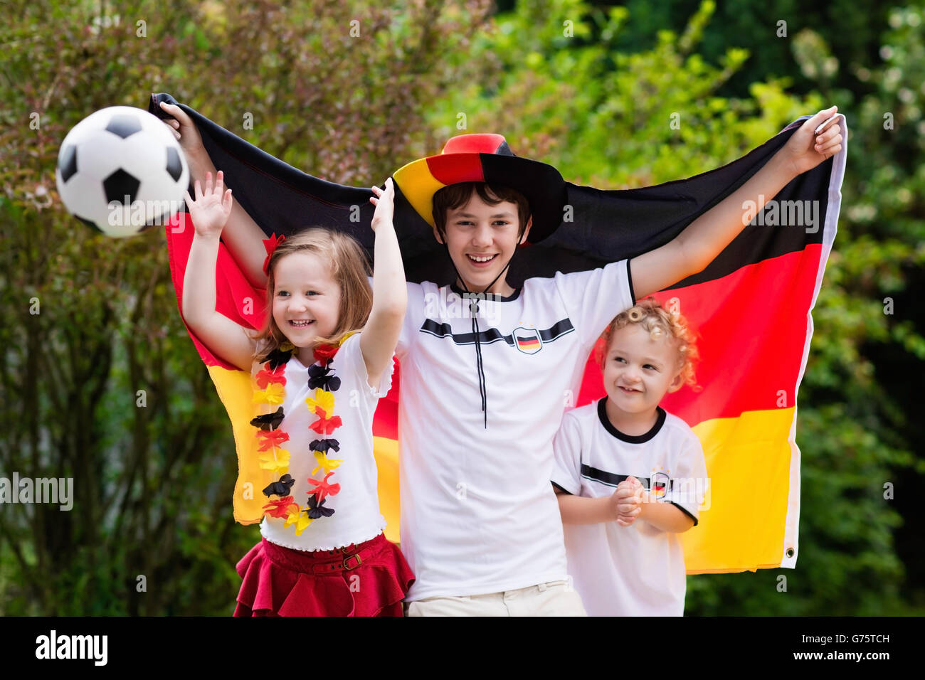 Children cheering and supporting German national football team. Kids