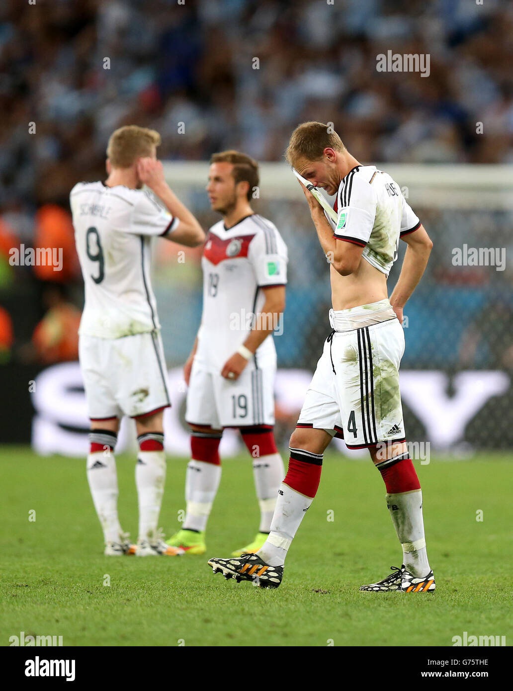 Germany's Benedikt Howedes wipes his face with his shirt before extra time during the FIFA World Cup Final at the Estadio do Maracana, Rio de Janerio, Brazil. Stock Photo