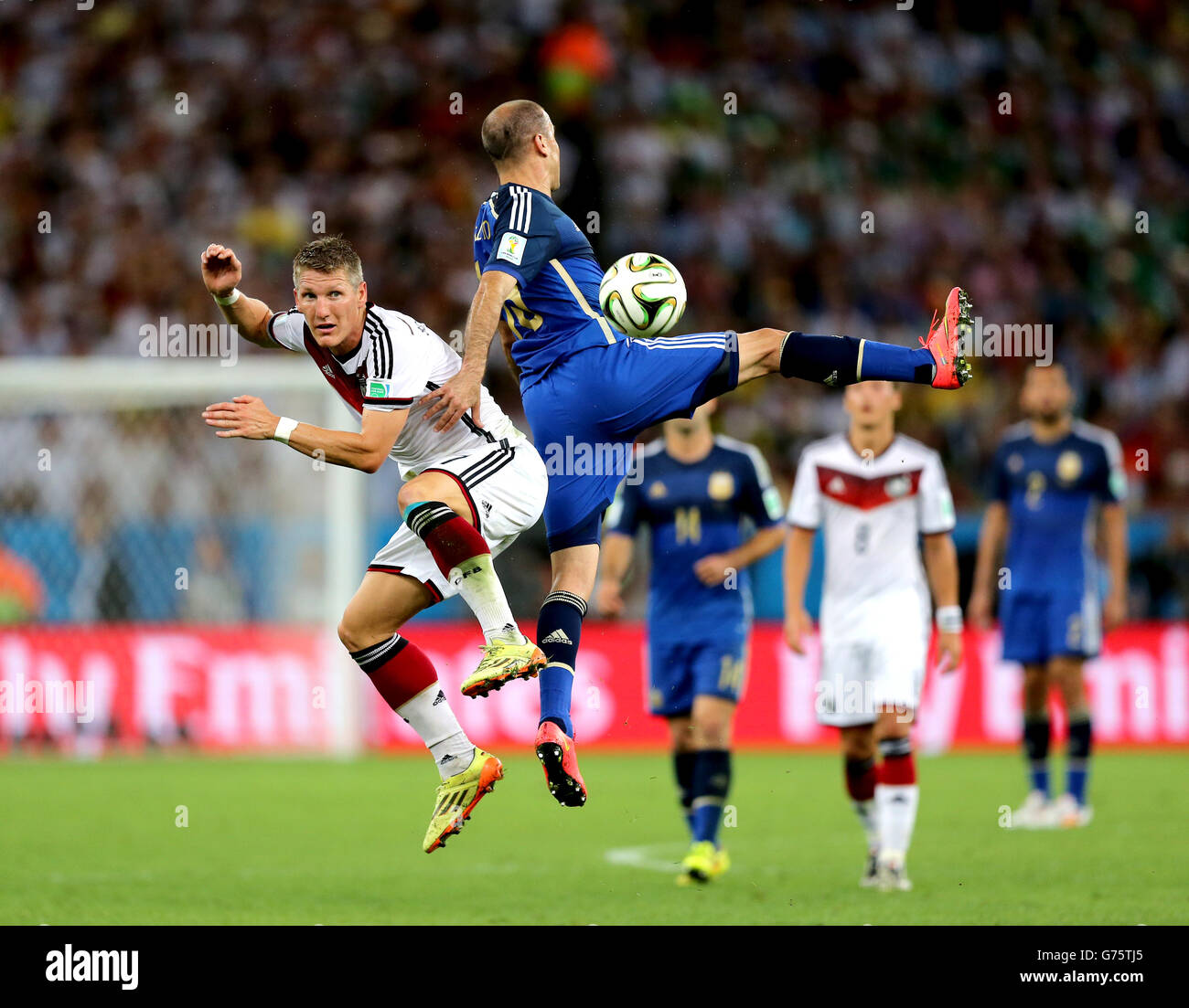 Soccer - FIFA World Cup 2014 - Final - Germany v Argentina - Estadio do Maracana. Germany's Bastian Schweinsteiger (left) and Argentina's Rodrigo Palacio battle for the ball Stock Photo