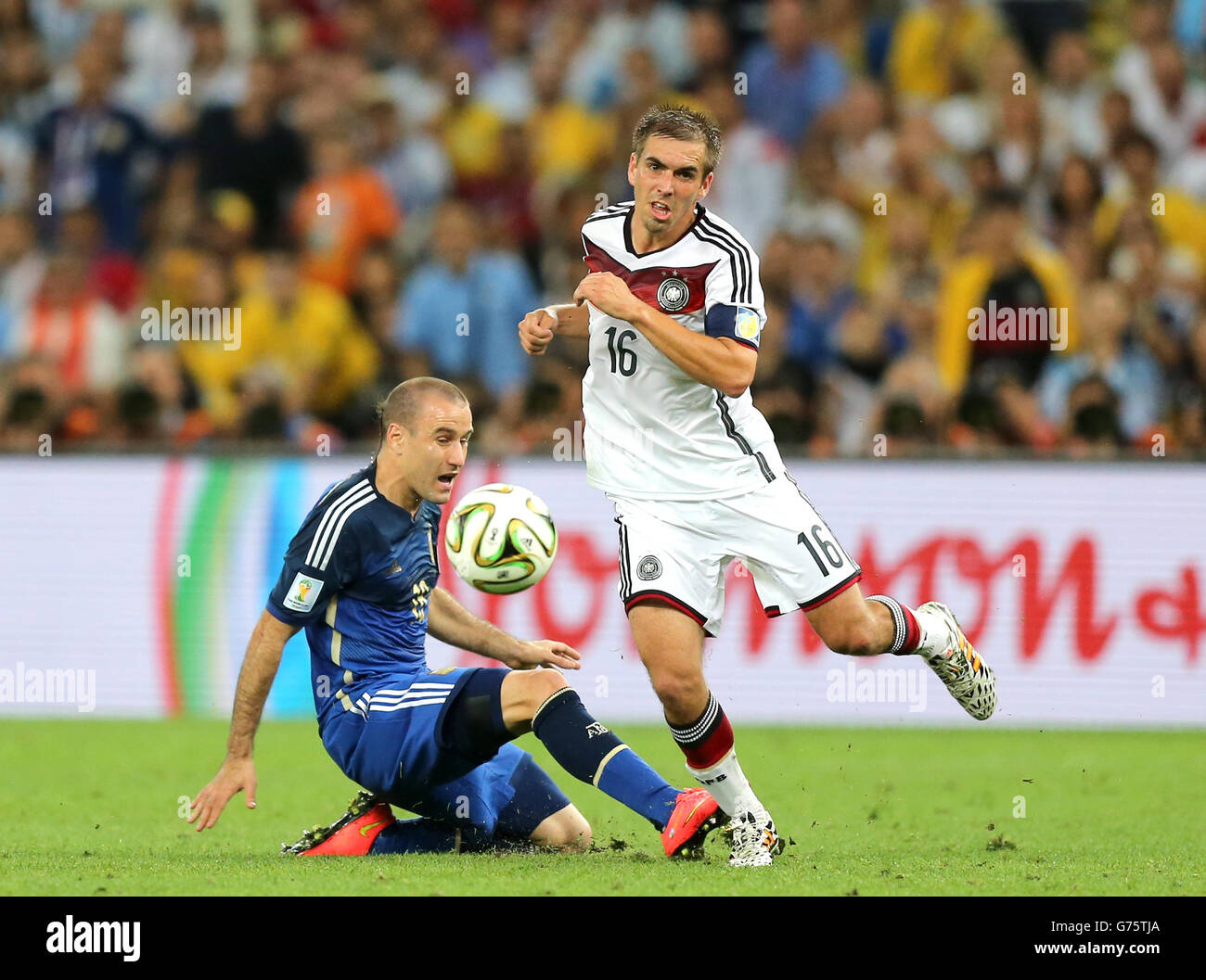 Germany's Philip Lahm (right) and Argentina's Rodrigo Palacio battle for the ball Stock Photo