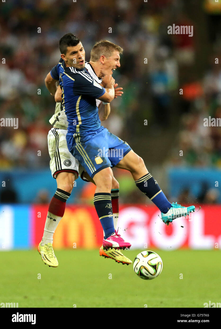Soccer - FIFA World Cup 2014 - Final - Germany v Argentina - Estadio do Maracana. Germany's Bastian Schweinsteiger (right) collides with Argentina's Sergio Aguero Stock Photo
