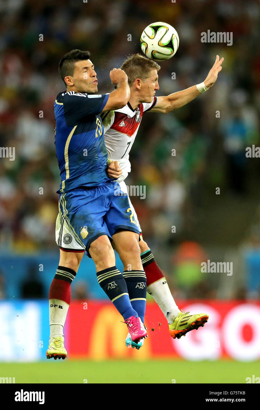 Soccer - FIFA World Cup 2014 - Final - Germany v Argentina - Estadio do Maracana. Germany's Bastian Schweinsteiger (right) collides with Argentina's Sergio Aguero Stock Photo