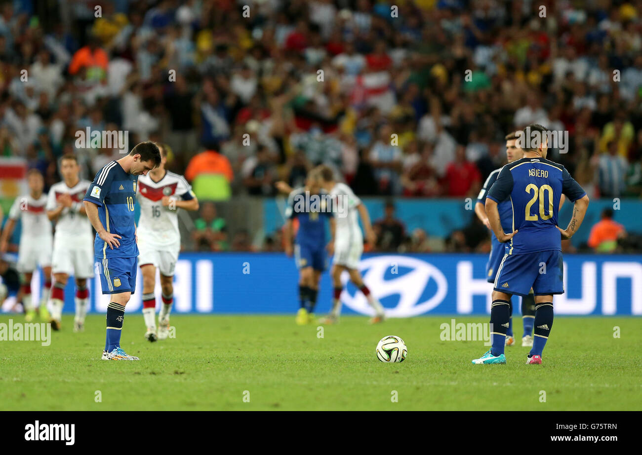 Argentina's Lionel Messi and Sergio Aguero (right) appear dejected as they wait to restart the match after Germany's Mario Gotze (not in picture) scores his team's opening goal during the FIFA World Cup Final at the Estadio do Maracana, Rio de Janerio, Brazil. Stock Photo