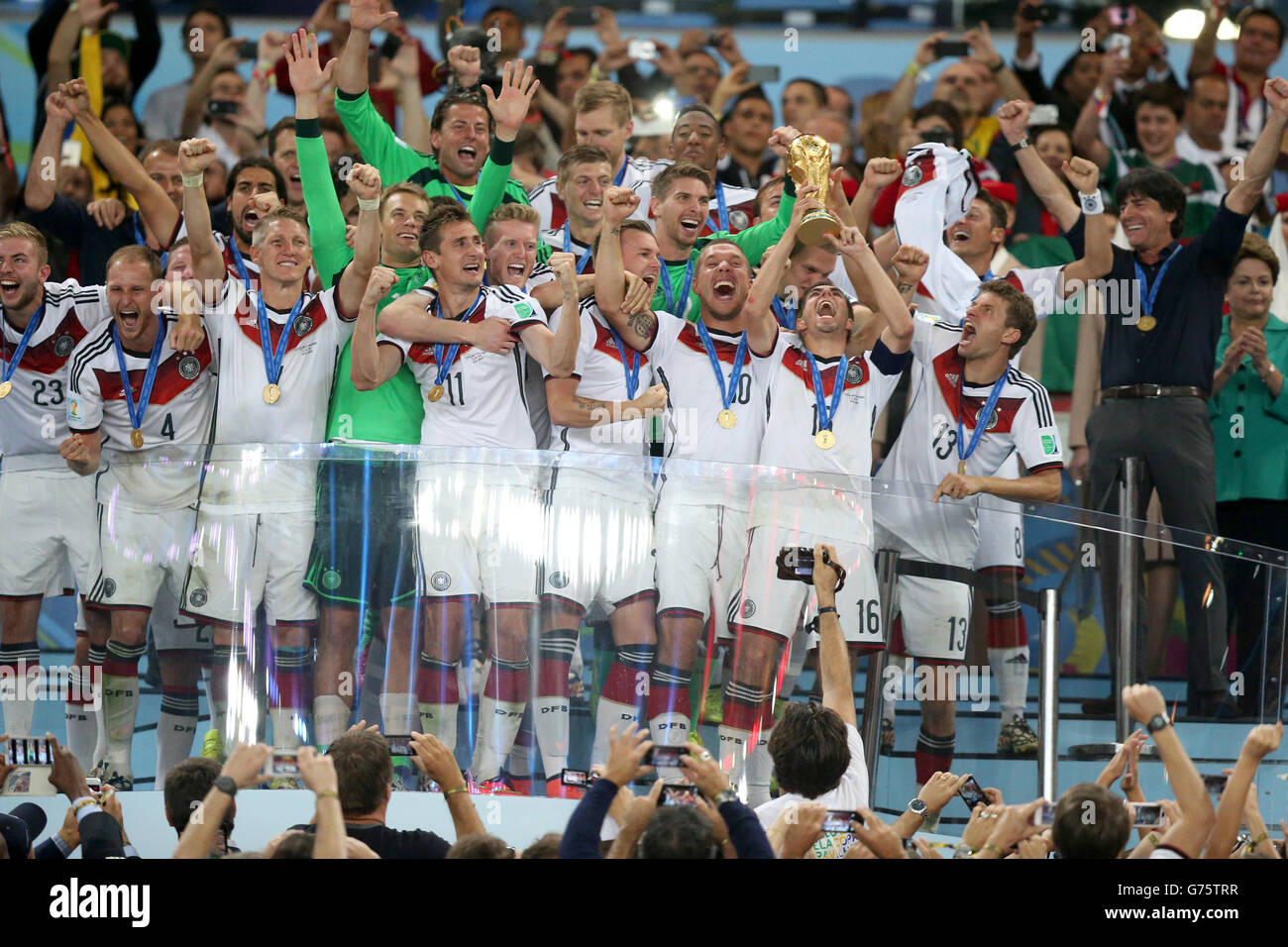 Germany's Philipp Lahm lifts the World Cup trophy as he celebrates winning the World Cup with team-mates at the Estadio do Maracana, Rio de Janerio, Brazil. Stock Photo