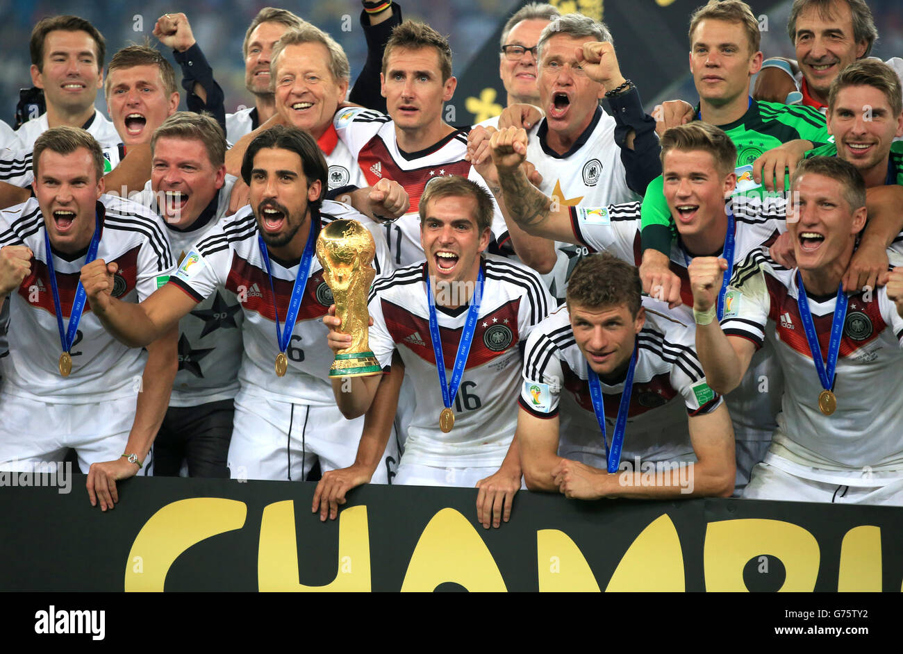 Germany's Philip Lahm celebrates on the pitch alongside teammates with the FIFA World Cup 2014 Trophy Stock Photo