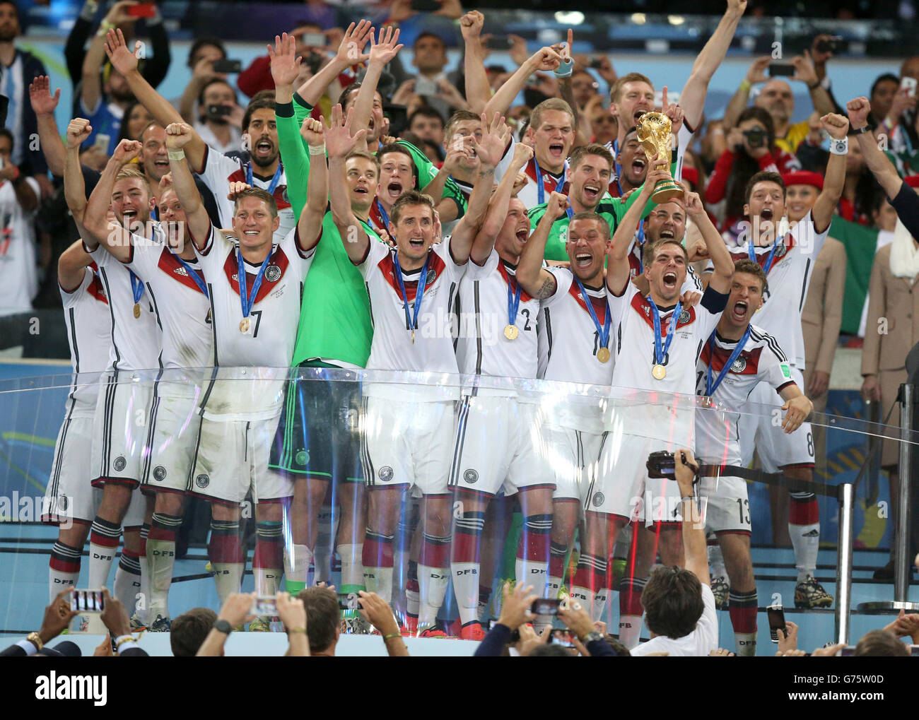 Germany's Philipp Lahm lifts the World Cup and celebrates victory with team-mates after during the FIFA World Cup Final at the Estadio do Maracana, Rio de Janerio, Brazil. Stock Photo