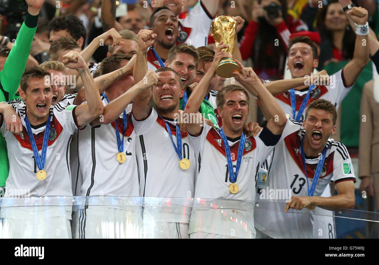 Germany's Philipp Lahm lifts the World Cup and celebrates victory with team-mates after the FIFA World Cup Final at the Estadio do Maracana, Rio de Janerio, Brazil. Stock Photo