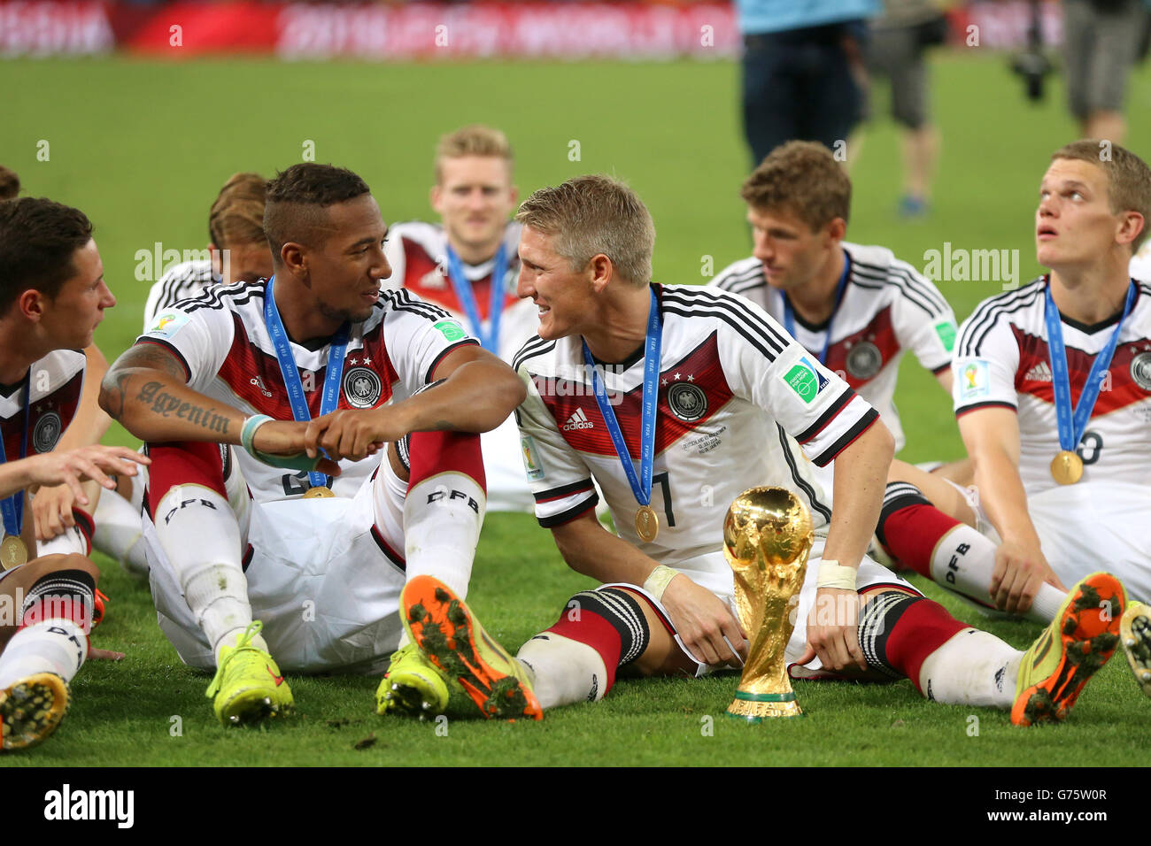 Germany's Bastian Schweinsteiger and Jerome Boateng (left) celebrate victory in the FIFA World Cup Final at the Estadio do Maracana, Rio de Janerio, Brazil. Stock Photo