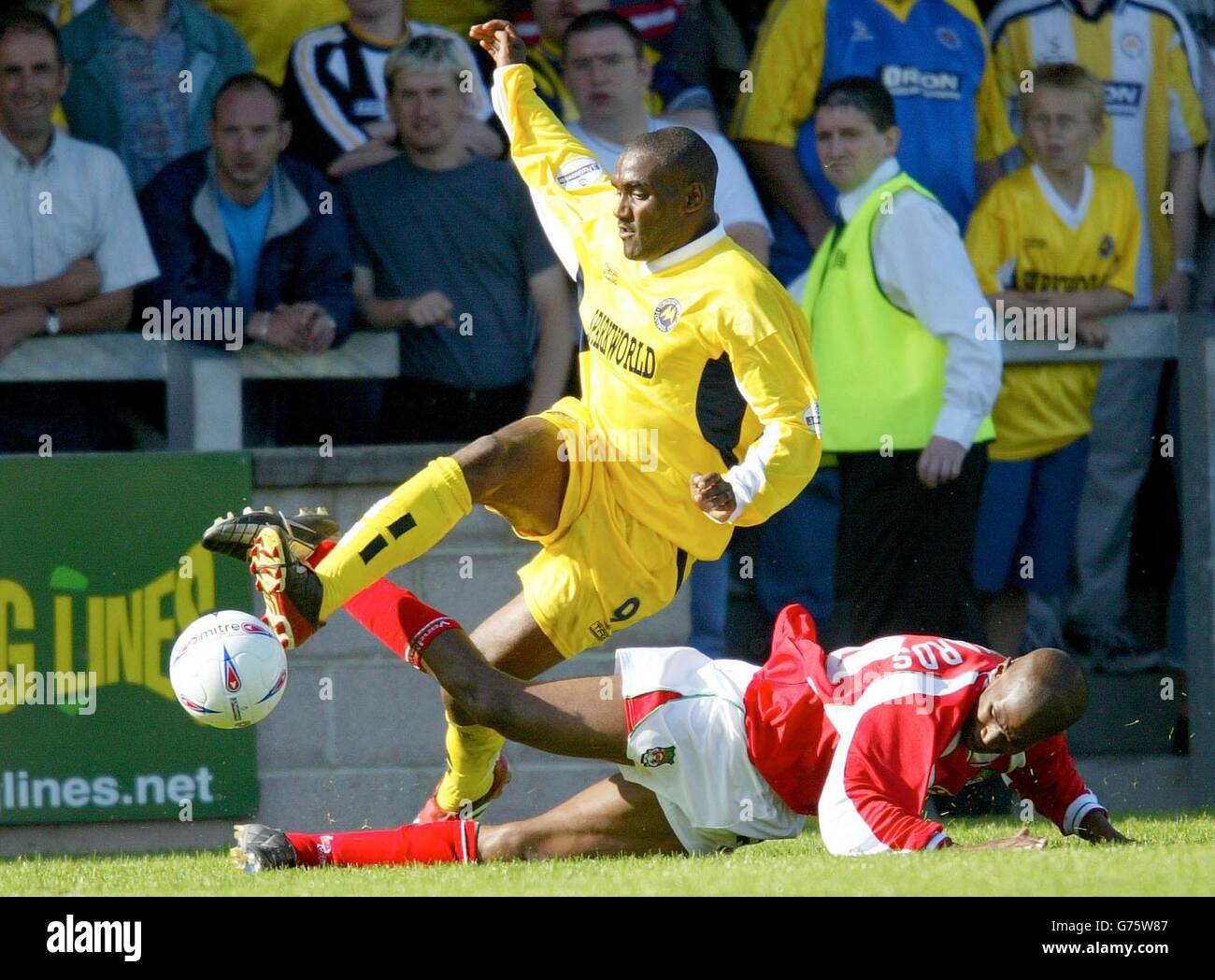 Torquay's Tony Bedeau is brought down by Wrexham's Paul Edwards to give Torquay a penalty during the Nationwide Division Three game at Plainmoor ground, Torquay. NO UNOFFICIAL CLUB WEBSITE USE. Stock Photo