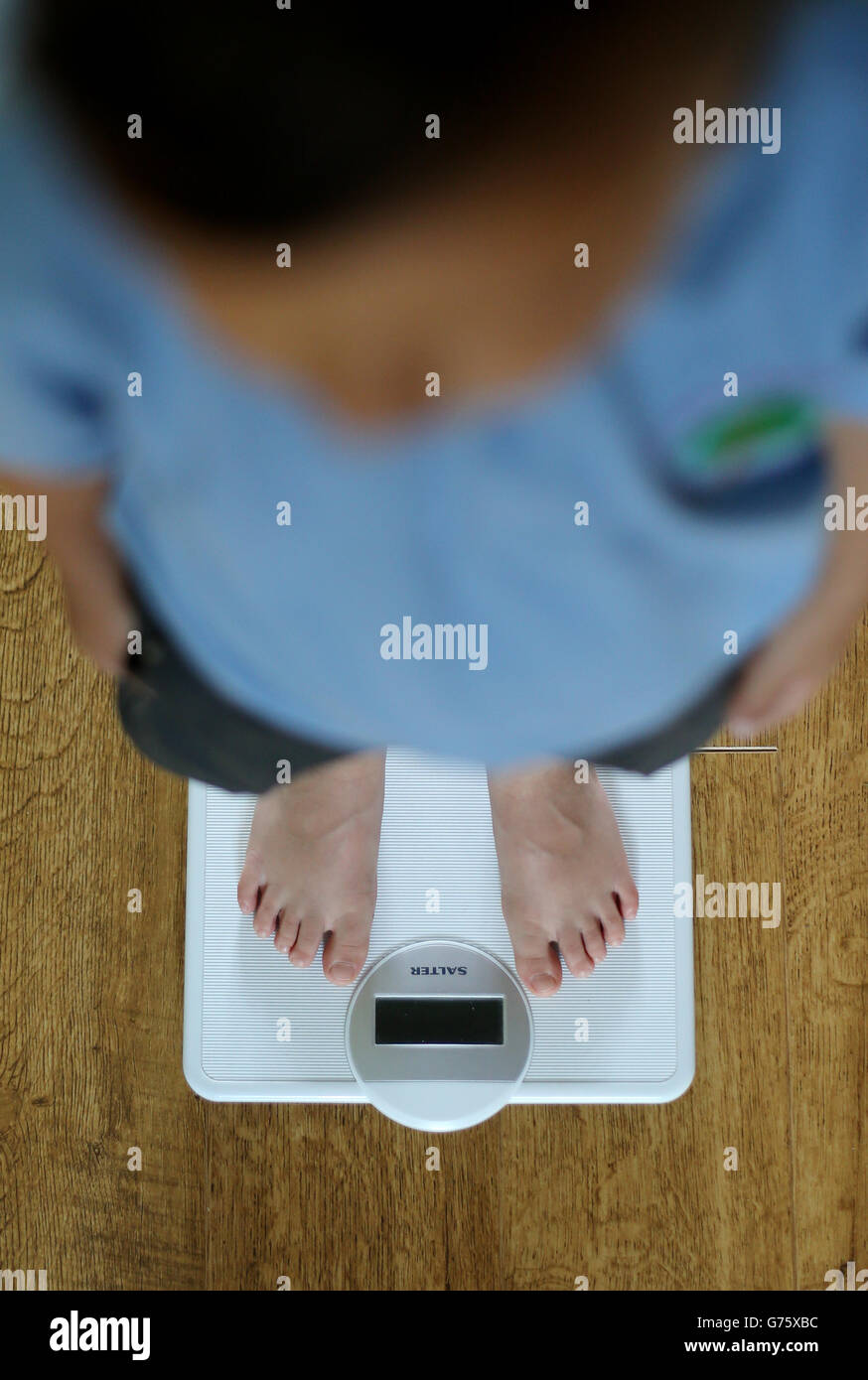 Child being weighed hi-res stock photography and images - Alamy